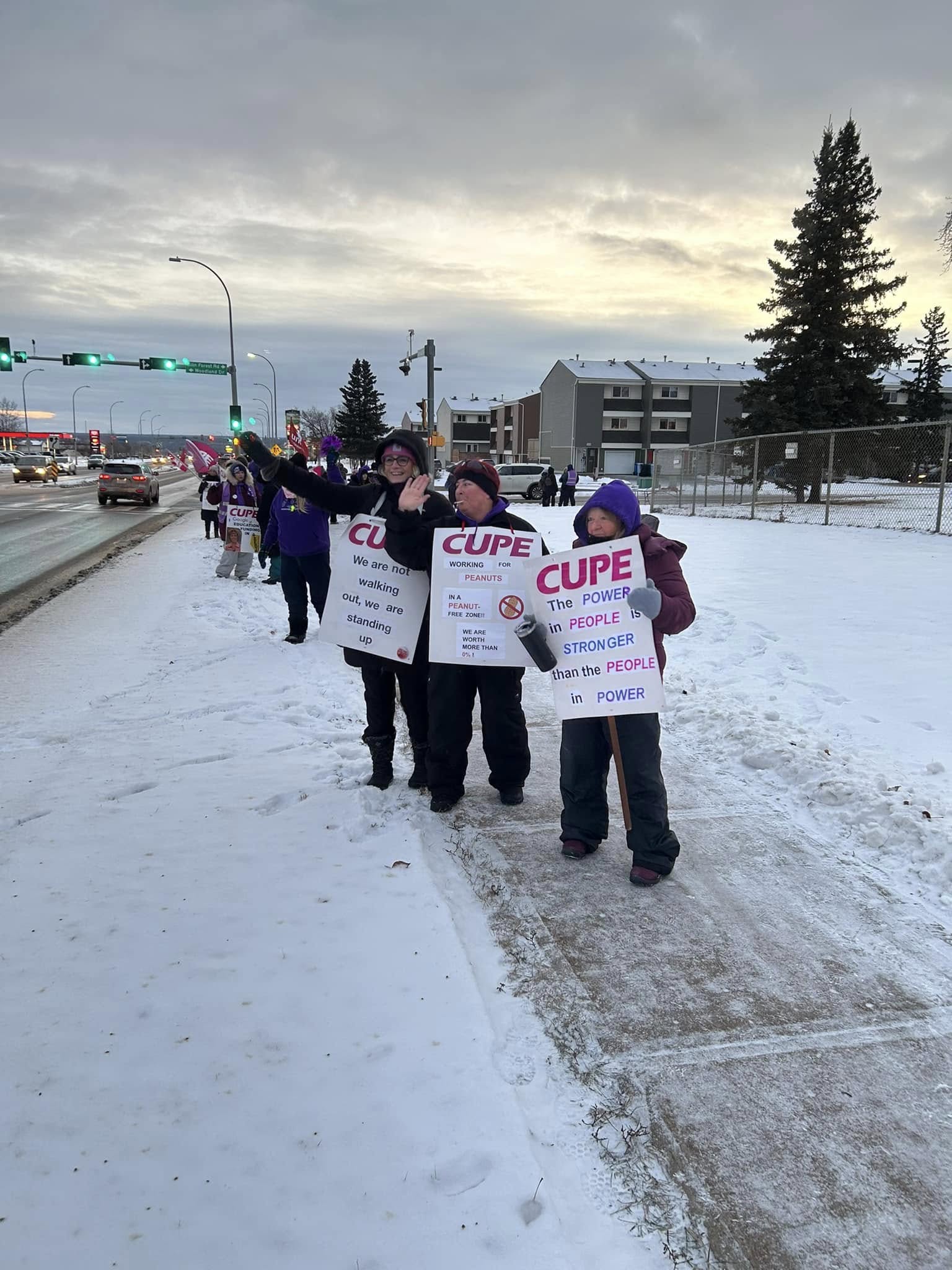 striking workers in front of a school in Fort McMurray